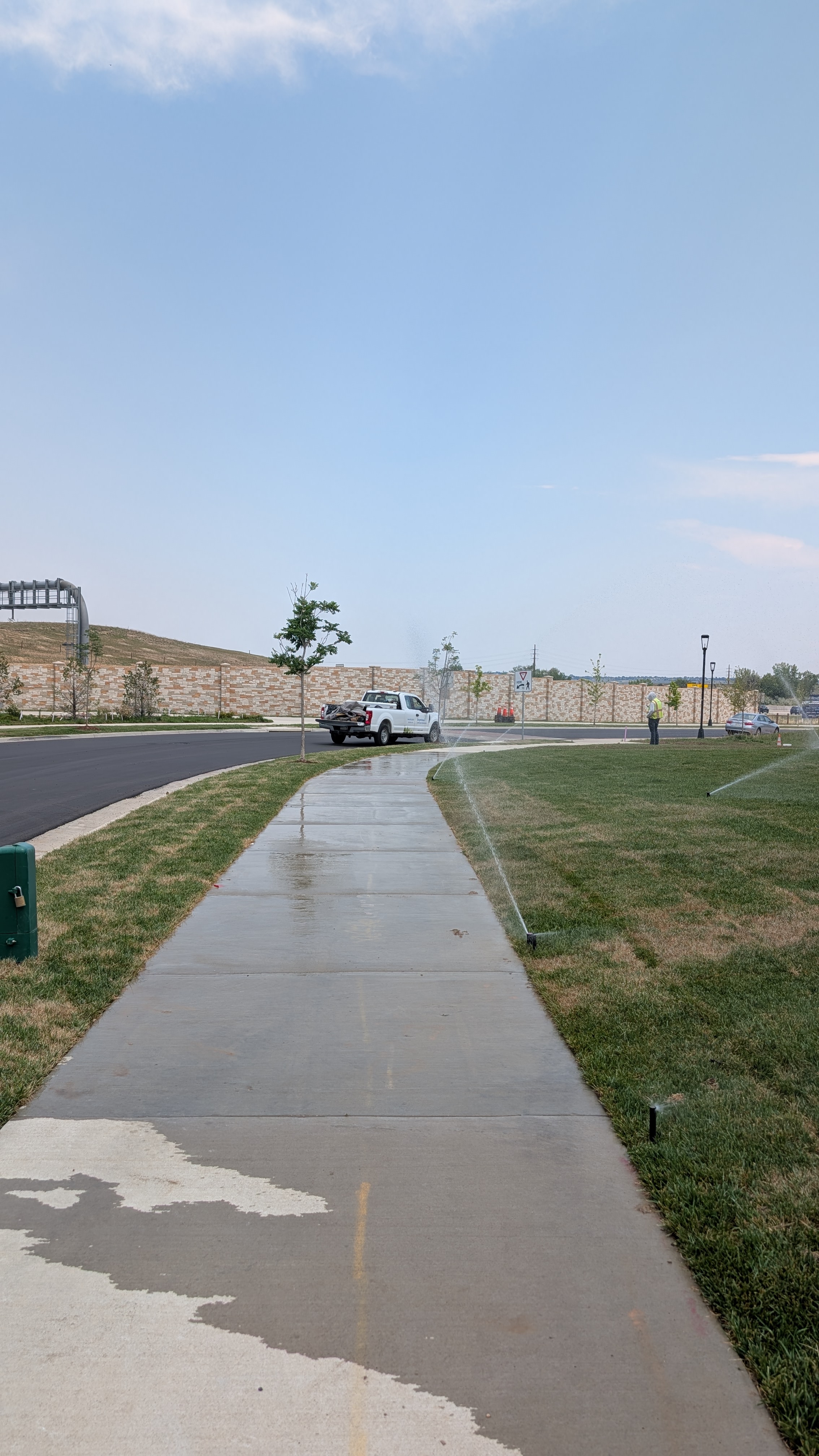 More wet sidewalks, and all while the landscapers watch on.